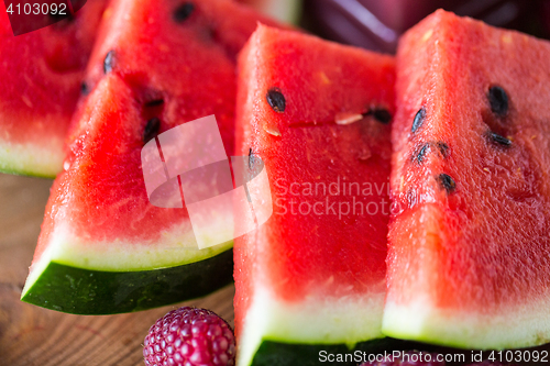 Image of close up of watermelon slices on wooden table