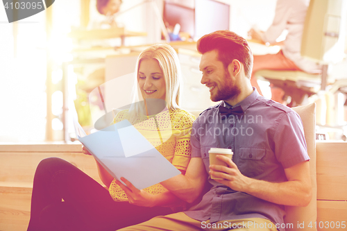 Image of office workers with folder and coffee