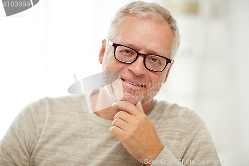 Image of close up of smiling senior man in glasses thinking