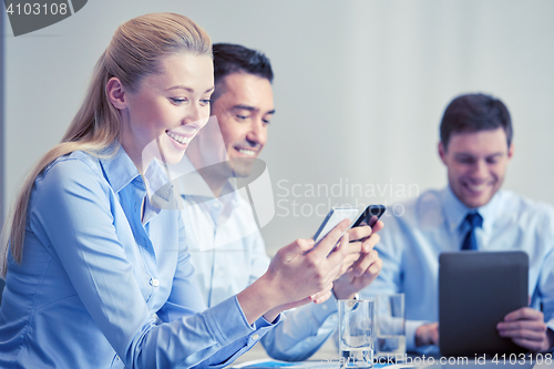 Image of businesspeople with smartphones and tablet pc