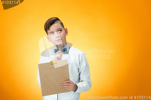 Image of The boy with pen and tablet for notes