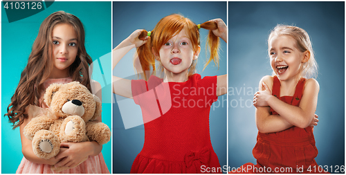 Image of The cute cheerful little girls on blue background