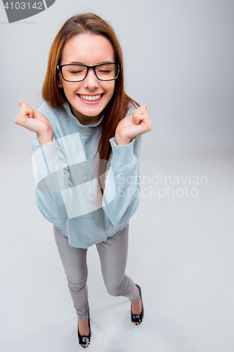 Image of The smiling young business woman on gray background