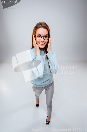 Image of The smiling young business woman on gray background