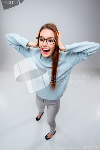 Image of The smiling young business woman on gray background