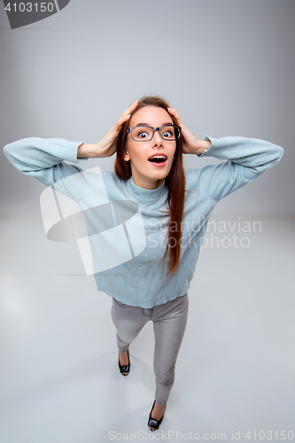 Image of The smiling young business woman on gray background