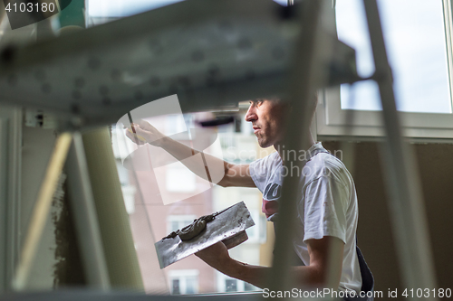 Image of Plasterer renovating indoor walls and ceilings.