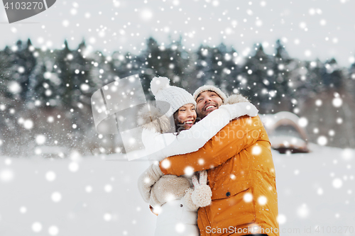 Image of happy couple hugging and laughing in winter