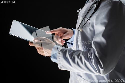 Image of close up of doctor with tablet pc and stethoscope