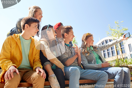 Image of happy teenage students taking selfie by smartphone