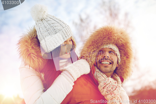 Image of happy couple having fun over winter background