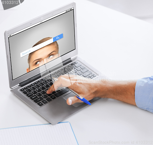 Image of businessman with laptop computer working at office