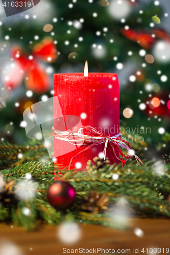 Image of fir branch wreath with candle on wooden table