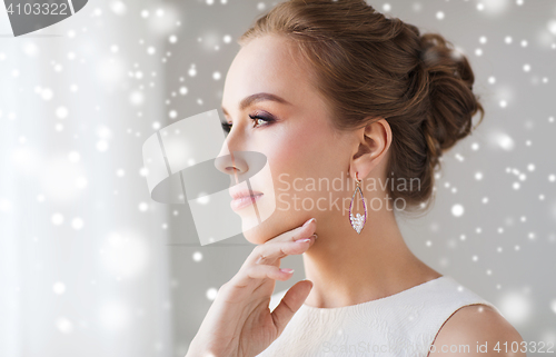 Image of beautiful woman in white with pearl earring