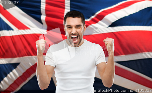 Image of angry man showing fists over brittish flag