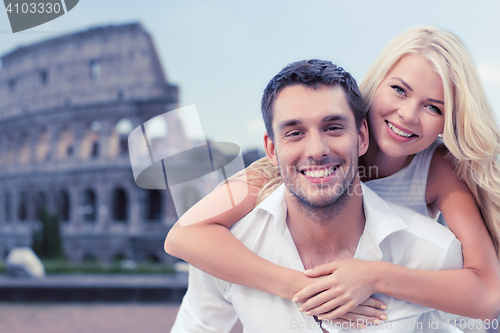 Image of happy couple hugging over coliseum