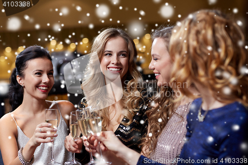 Image of happy women with champagne glasses at night club