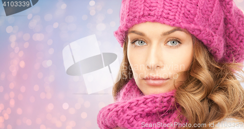 Image of close up of woman in hat and scarf over lights