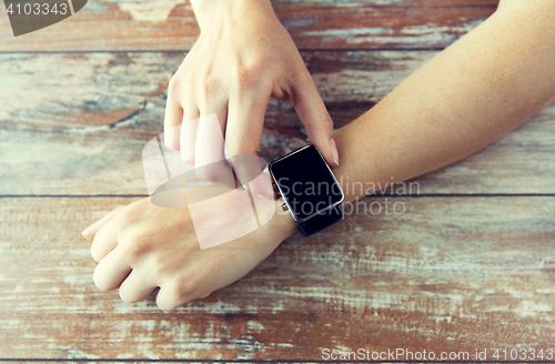 Image of close up of hands setting smart watch