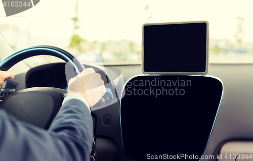 Image of close up of businessman with tablet pc driving car
