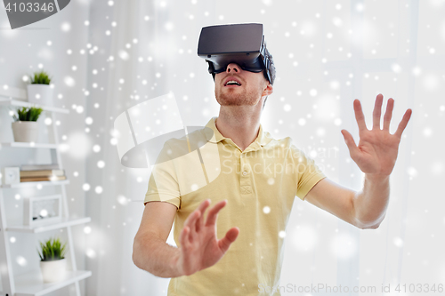 Image of young man in virtual reality headset or 3d glasses