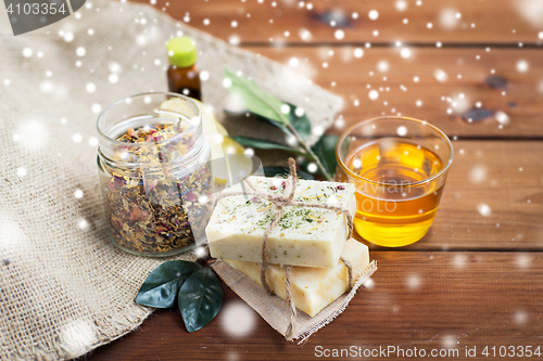 Image of handmade soap, honey and herbal tea on wood