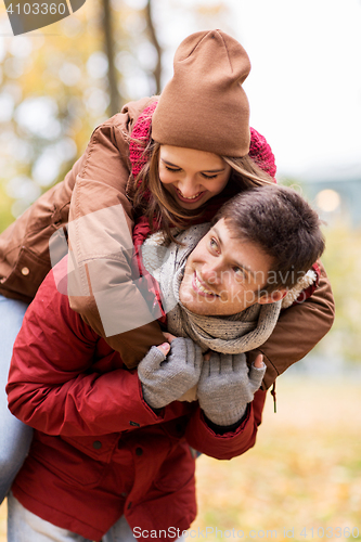 Image of happy young couple having fun in autumn park