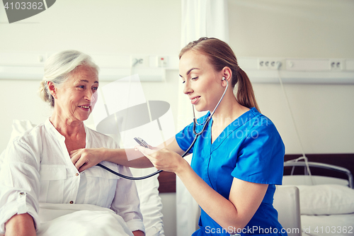 Image of nurse with stethoscope and senior woman at clinic