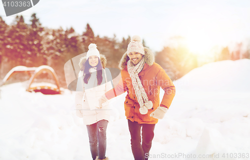 Image of happy couple running over winter background