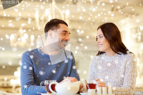 Image of happy couple drinking tea at cafe