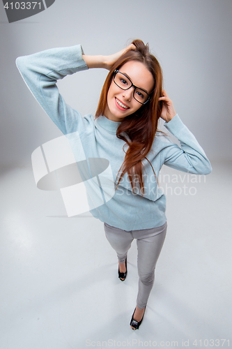 Image of The smiling young business woman on gray background