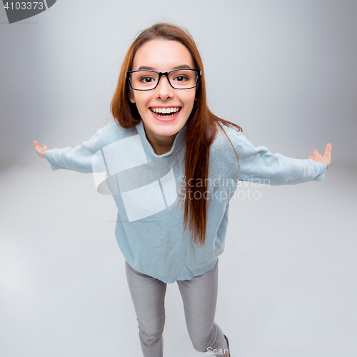 Image of The smiling young business woman on gray background