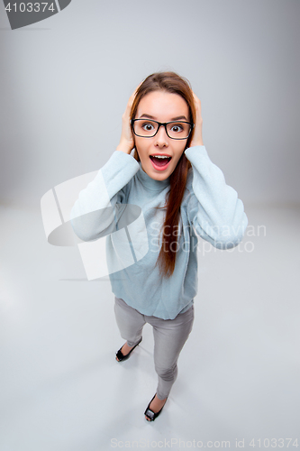 Image of The smiling young business woman on gray background