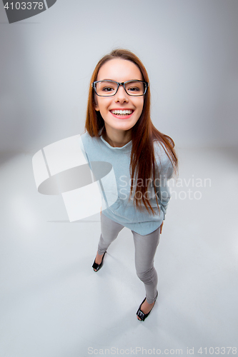 Image of The smiling young business woman on gray background