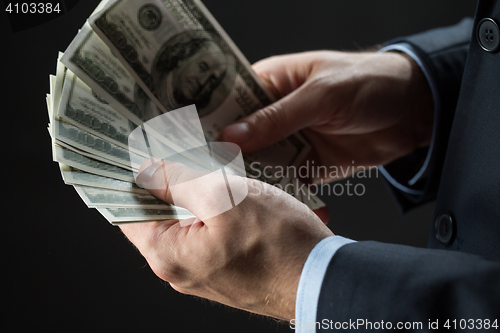 Image of close up of businessman hands holding money