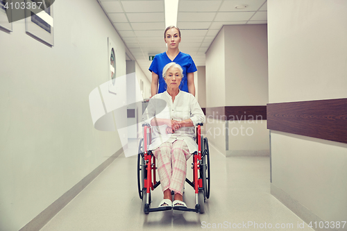 Image of nurse with senior woman in wheelchair at hospital