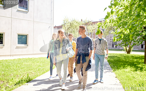 Image of group of happy teenage students walking outdoors