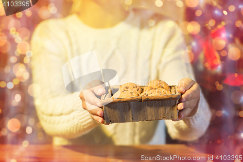 Image of close up of woman with christmas oat cookies 
