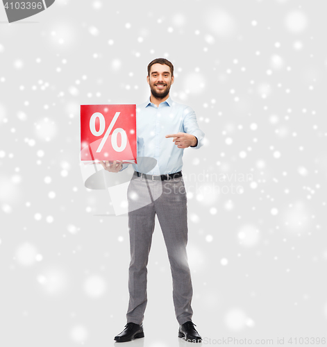 Image of smiling man with red percentage sign over snow
