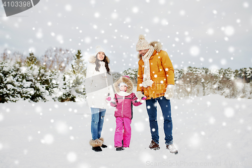 Image of happy family with child in winter clothes outdoors