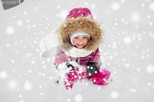 Image of f happy little child or girl with snow in winter