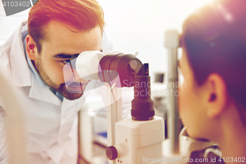 Image of optician with tonometer and patient at eye clinic