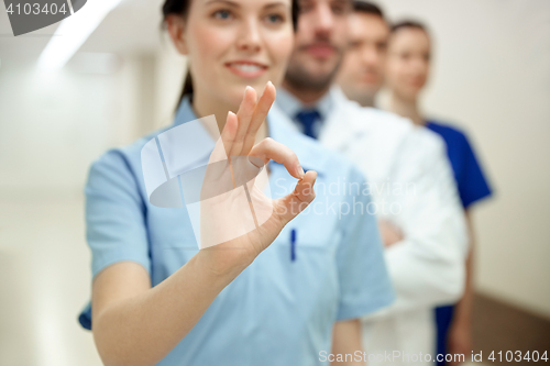 Image of close up of doctors at hospital showing ok sign