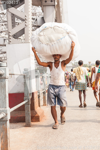 Image of Man carrying load on the Howrah Bridge