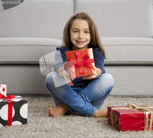 Image of Little girl opening presents