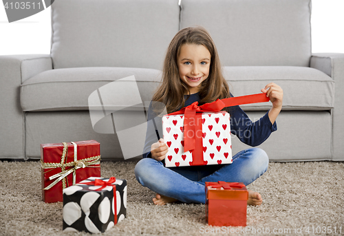 Image of Little girl opening presents