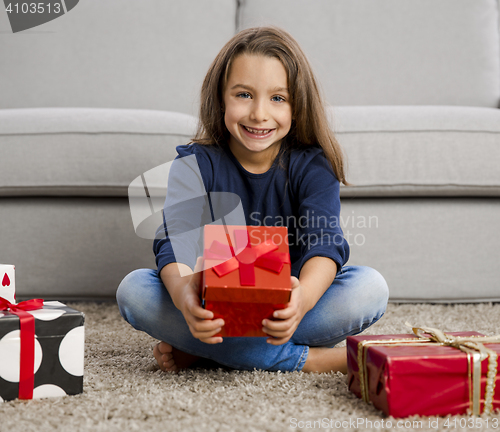 Image of Little girl opening presents