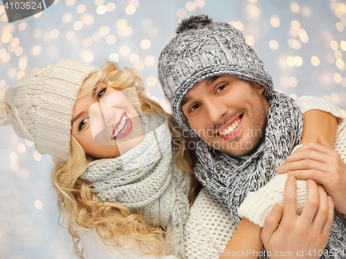 Image of happy family couple in winter clothes hugging