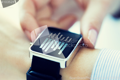 Image of close up of hands with chart on smartwatch screen