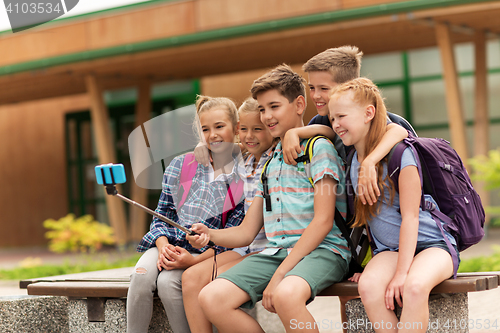 Image of happy elementary school students taking selfie